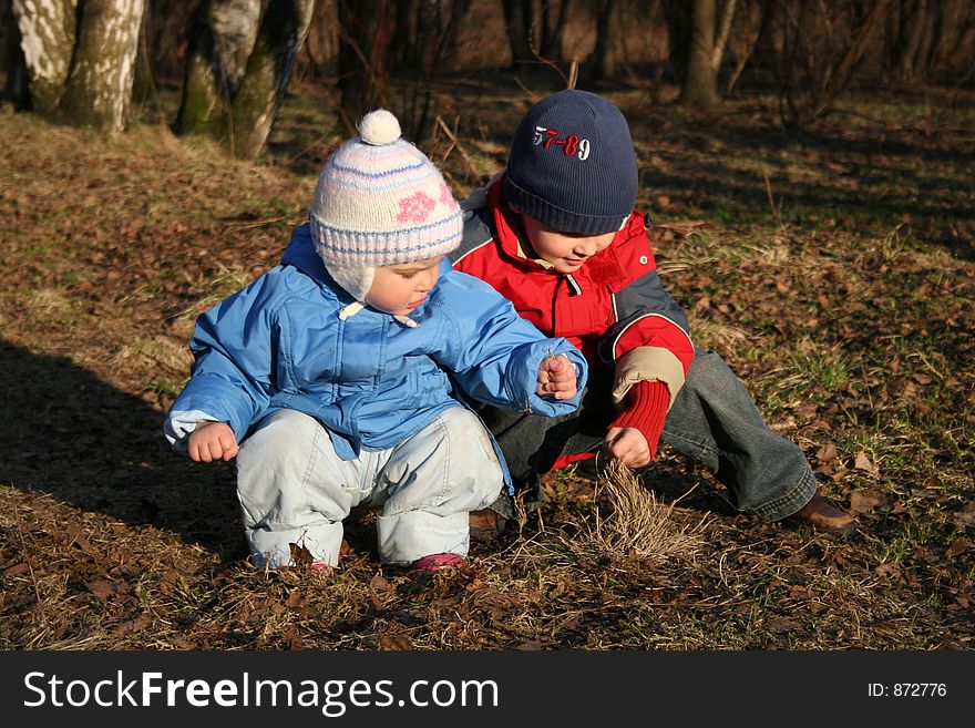 Child with baby sit in park