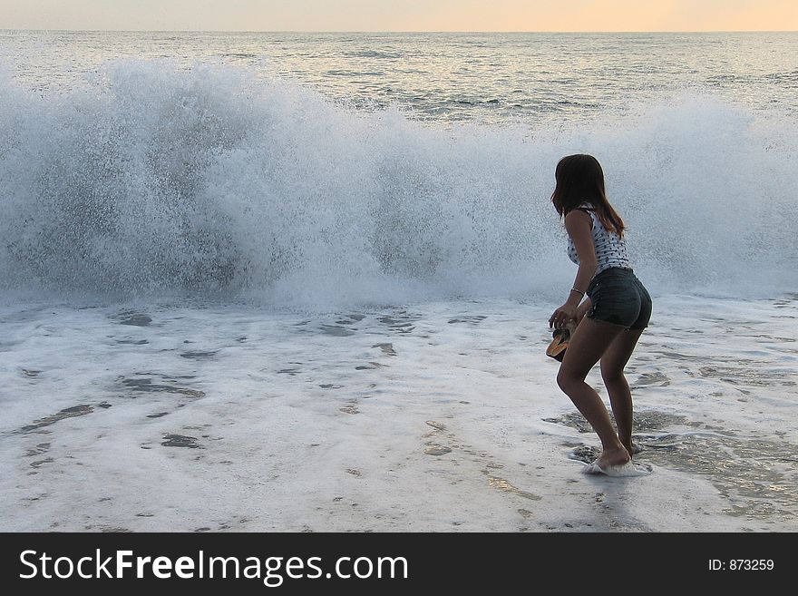 Girl playing with sea waves. Girl playing with sea waves