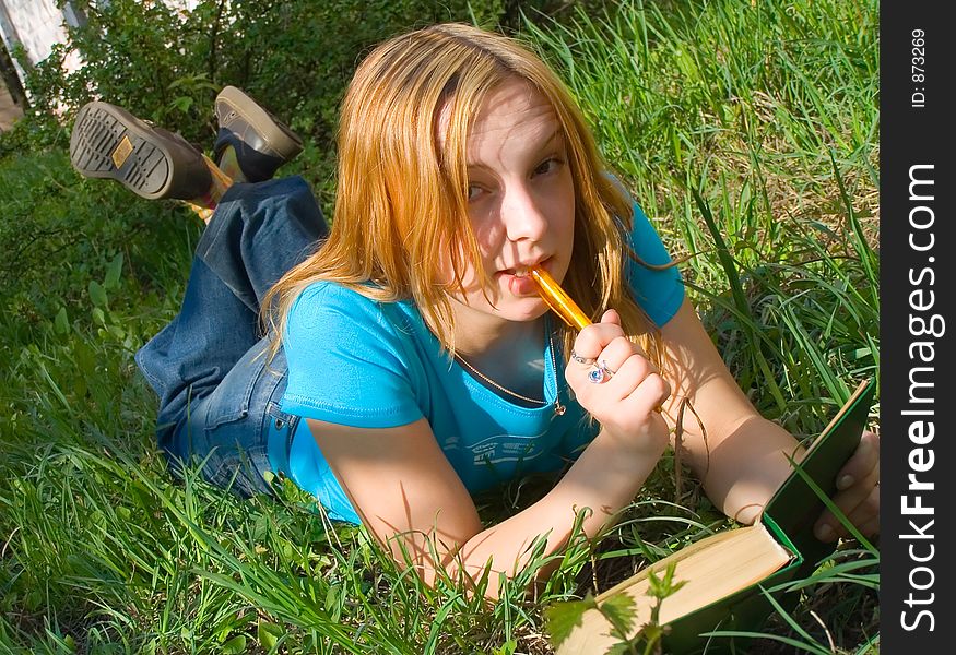 Girl Reads The Book Lying Down.