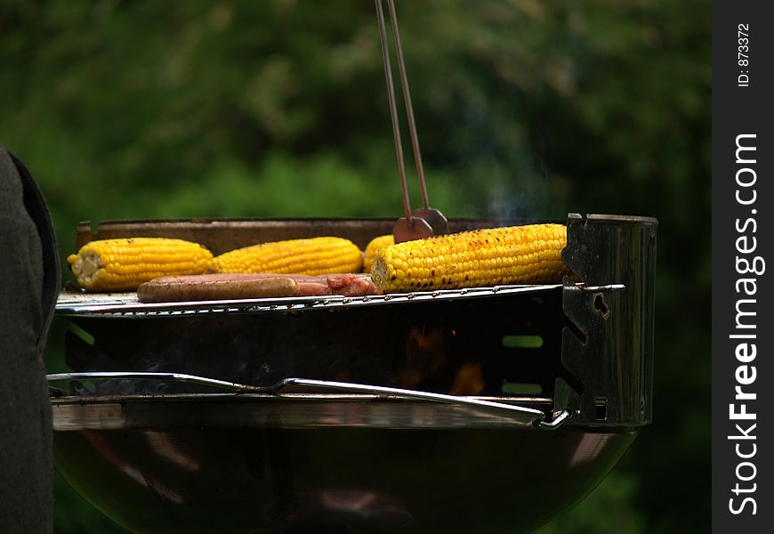 Nice filled barbeque with corn and sausages. Nice filled barbeque with corn and sausages
