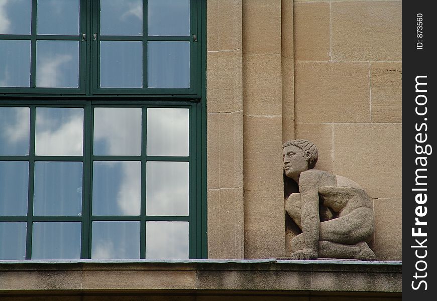 Art deco stone sculpture of man on windowsill. Art deco stone sculpture of man on windowsill