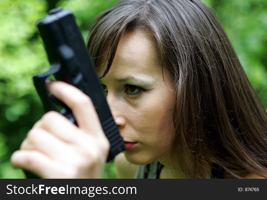 Portrait of a girl with a gun. Portrait of a girl with a gun