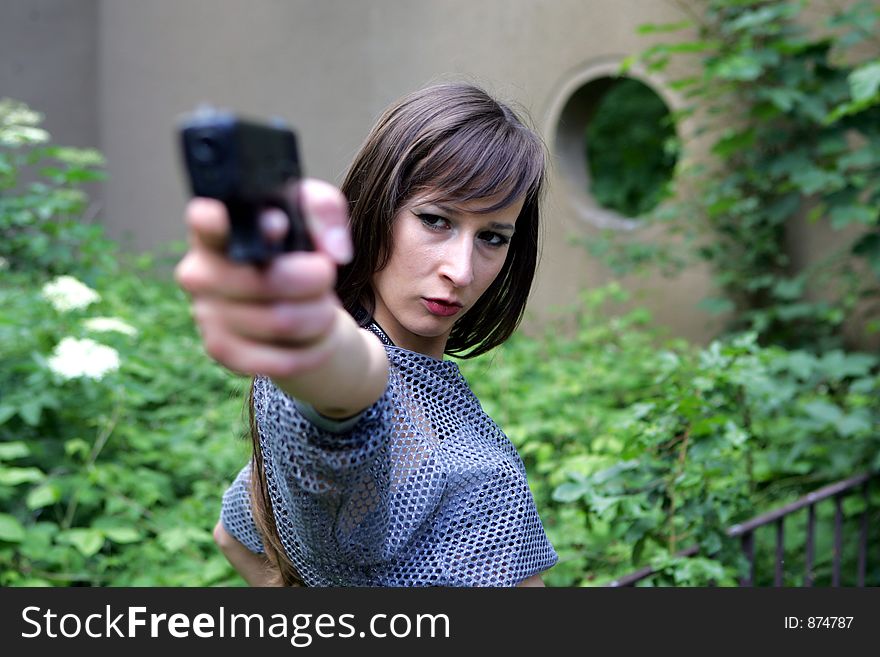 A Beautiful girl aiming at the camera. A Beautiful girl aiming at the camera