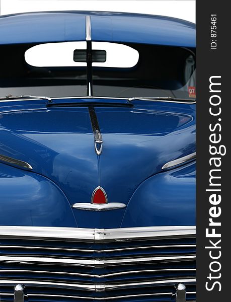 Photograph of the front end of an old classic car in mint condition, shining chrome and highly polished finish , absolutely beautiful, cropped shot isolated with clipping paths. Photograph of the front end of an old classic car in mint condition, shining chrome and highly polished finish , absolutely beautiful, cropped shot isolated with clipping paths