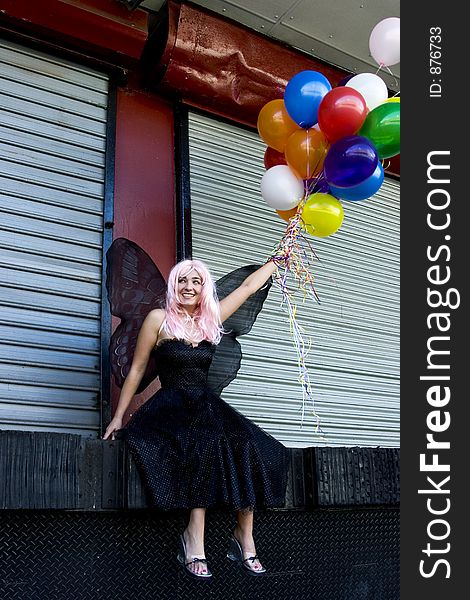 Fairy with balloons in an urban setting