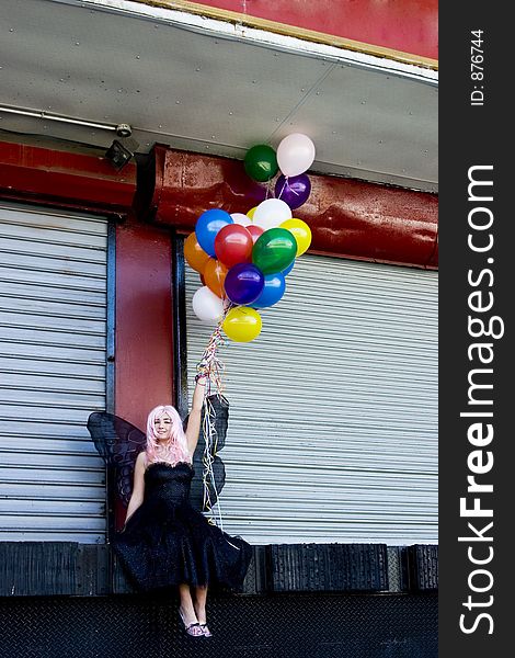 Fairy with balloons in an urban setting