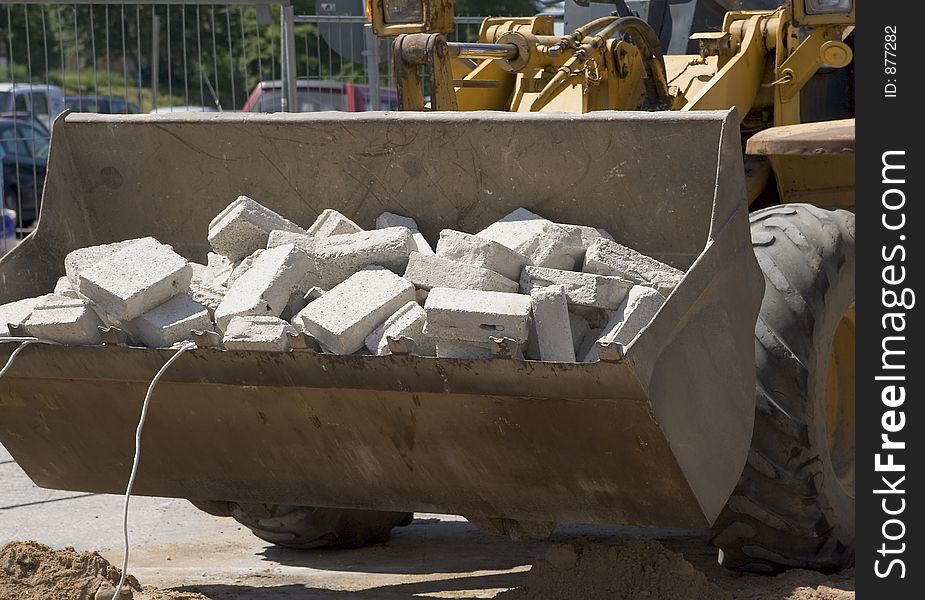 Yellow front loader in action. Yellow front loader in action