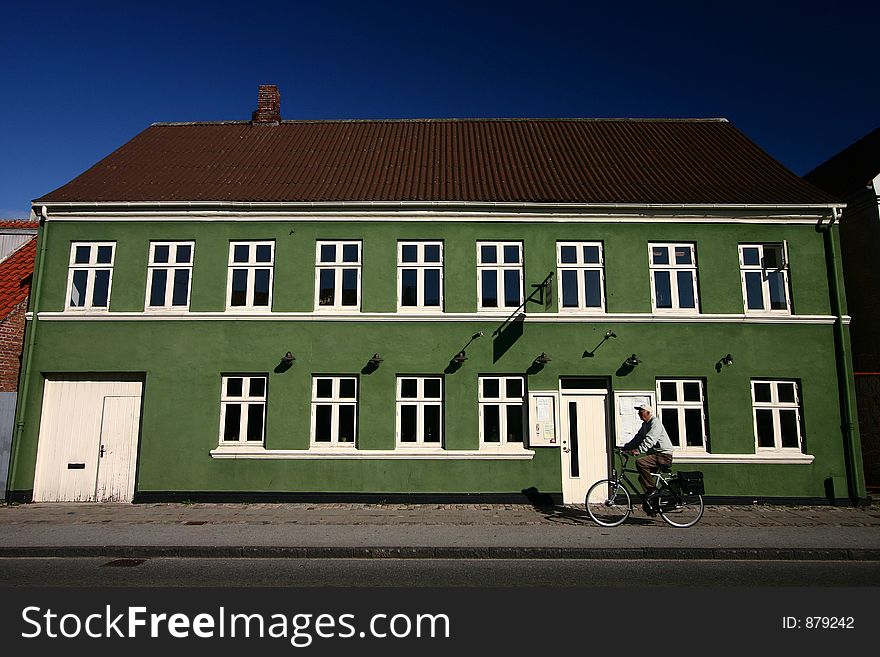 Traditional building in denmark, bike passing by. Traditional building in denmark, bike passing by