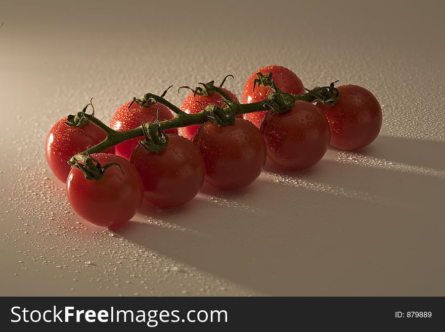 Cherry tomatoes with water drop and strong shadows. Cherry tomatoes with water drop and strong shadows.