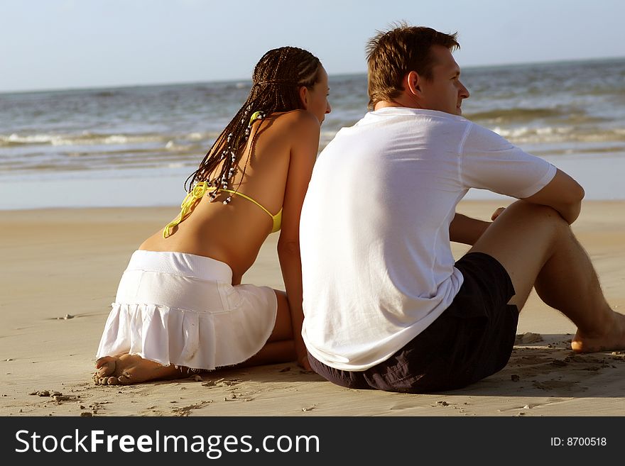 Natural couple at the beach by sunset