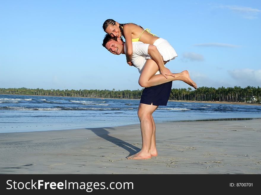 Natural couple at the beach by sunset