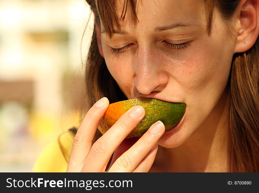 Girl eating fresh and tasty fruit outdoor. Girl eating fresh and tasty fruit outdoor