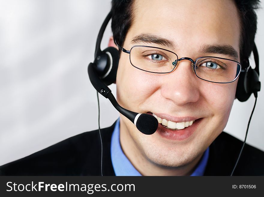 Young business man with headphone expressing positive and smiling