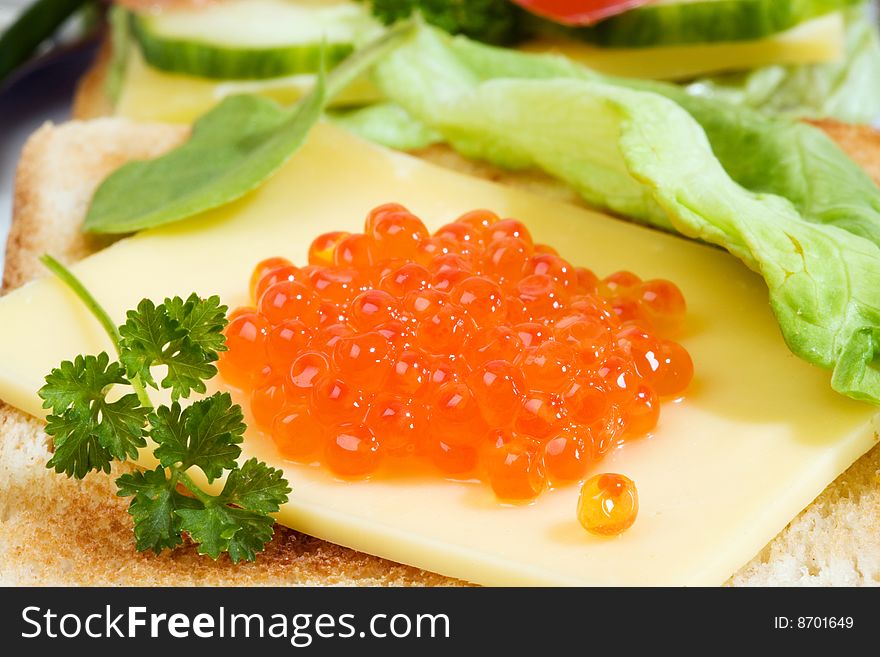 Toast with trout caviar, cheese and vegetables. Toast with trout caviar, cheese and vegetables.