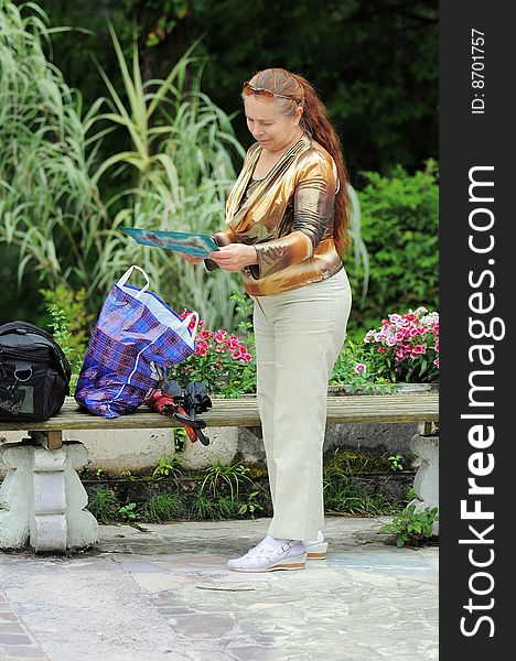 The woman has a rest in park. A tree nursery of a city of Sochi. Russia.