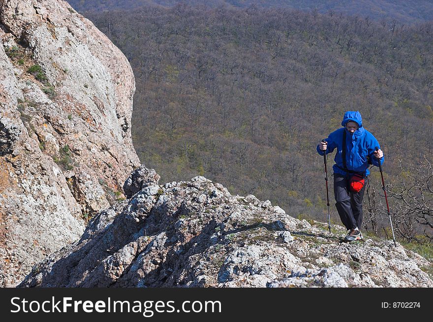 Hiking in mountains with sticks for walking in the cold summer. Hiking in mountains with sticks for walking in the cold summer.