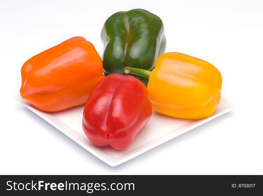 A orange, yellow, red and green fresh paprika. A orange, yellow, red and green fresh paprika