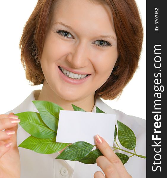 Smiling girl with a business card and leaves of plants. Focusing on the eyes. Smiling girl with a business card and leaves of plants. Focusing on the eyes