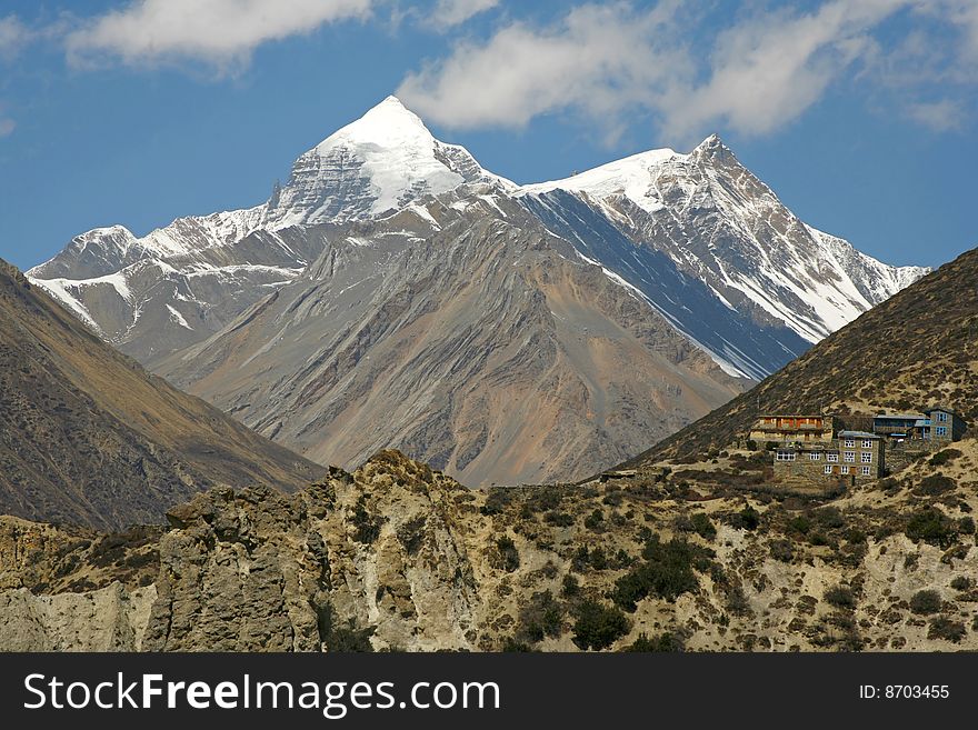 Annapurna mountain range and village on hill. Annapurna mountain range and village on hill