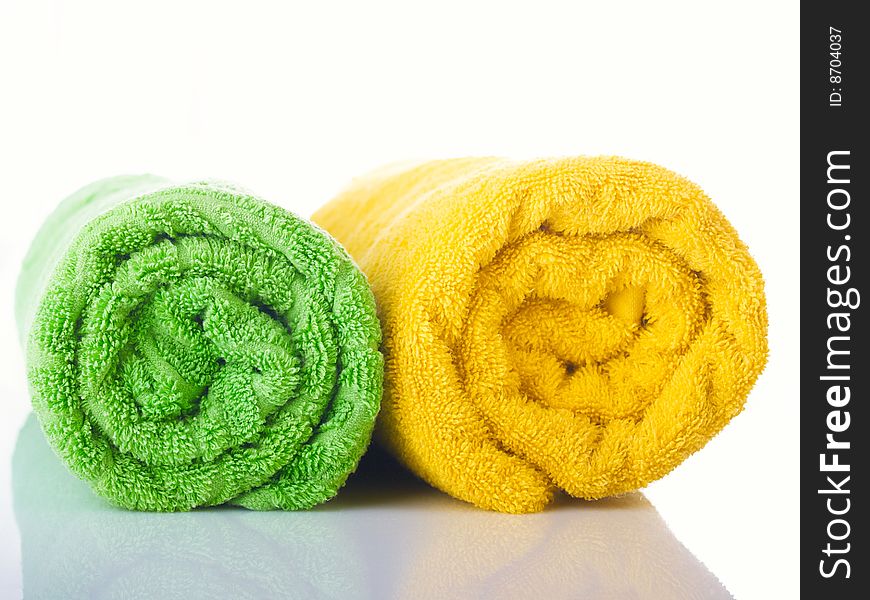 Two terry multi-coloured towels on a table