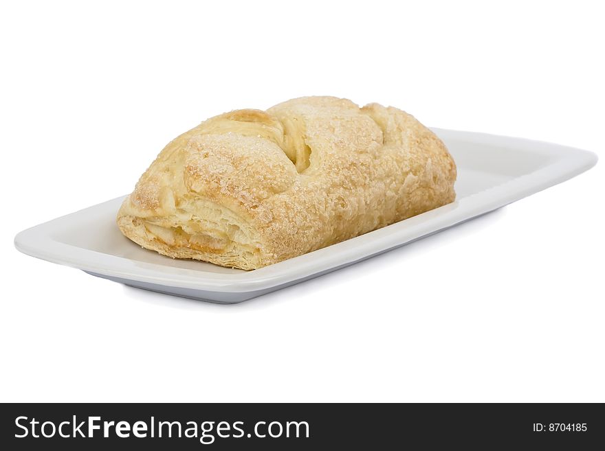 Appetizing bun on white plate isolated on white