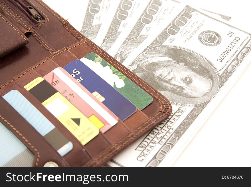 Fine leather wallet with credit cards inside and dollar bank notes isolated over white background, money concept.