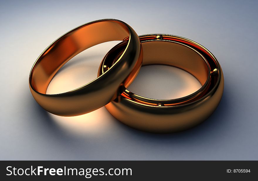 Two gold rings lie on a light background. Two gold rings lie on a light background