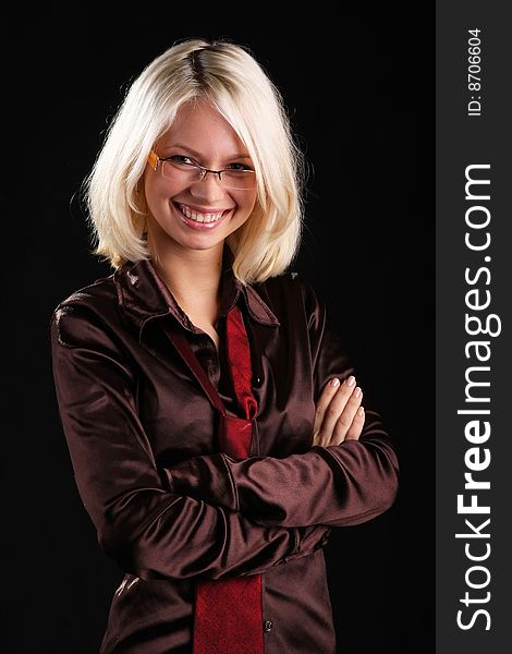 Smiling beautiful lady with necktie and glasses on a black background