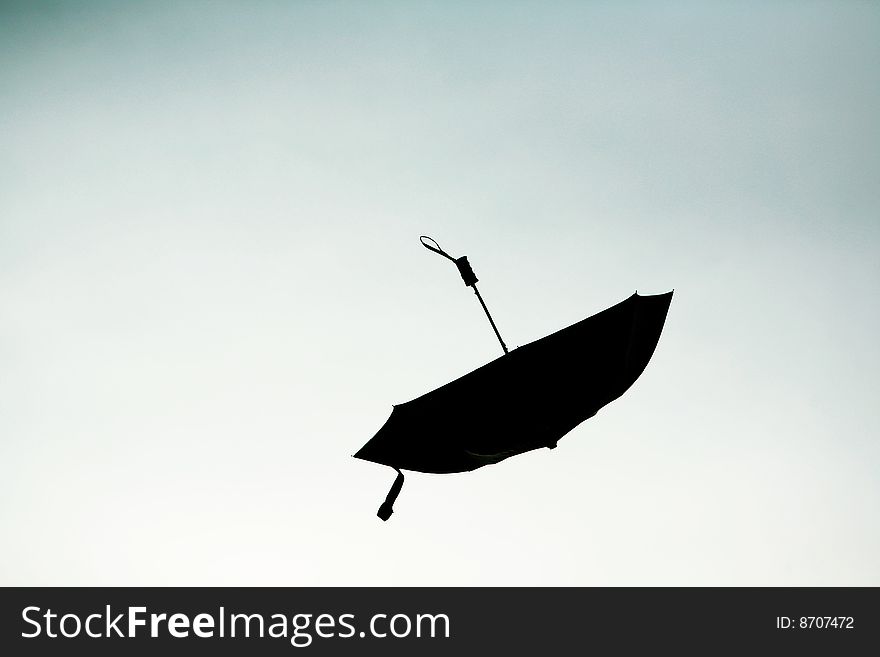 Silhouette of an umbrella against the sky. Silhouette of an umbrella against the sky