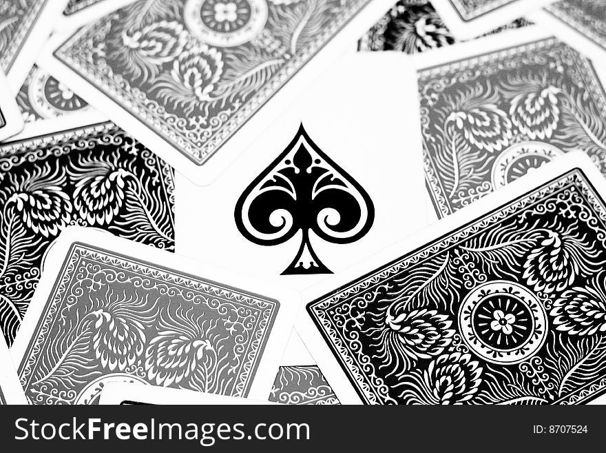 Ace of spades in the centre with other playing cards surrounding it