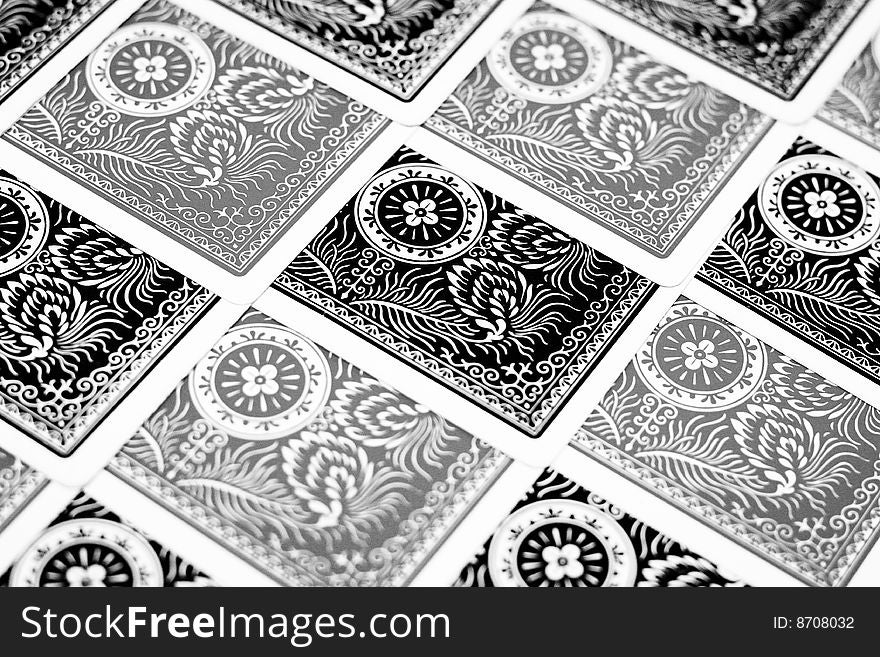 Black and grey playing cards faced down and arranged in a orderly manner. Black and grey playing cards faced down and arranged in a orderly manner.