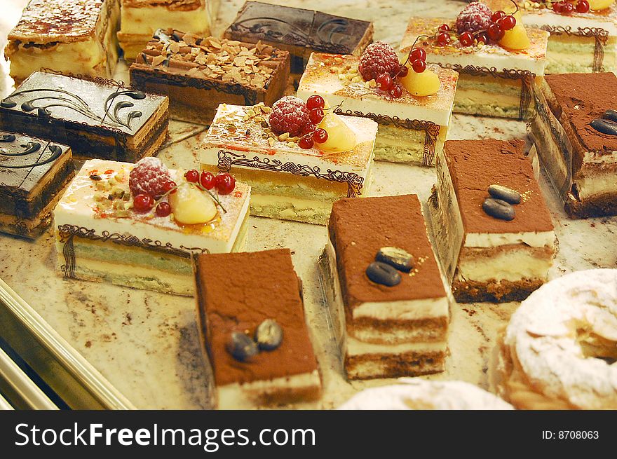 Various small cakes in a confectionery. Various small cakes in a confectionery.