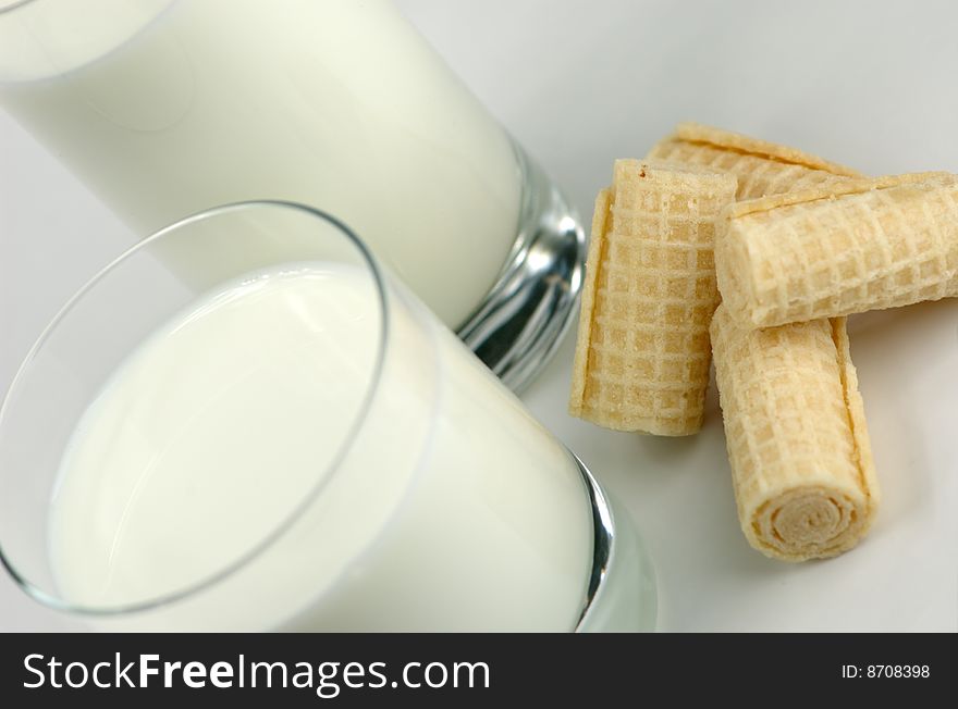 Glass of milk and fresh cookies on a white background. Glass of milk and fresh cookies on a white background