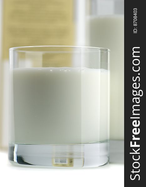 Glass of milk and fresh cookies on a white background. Glass of milk and fresh cookies on a white background