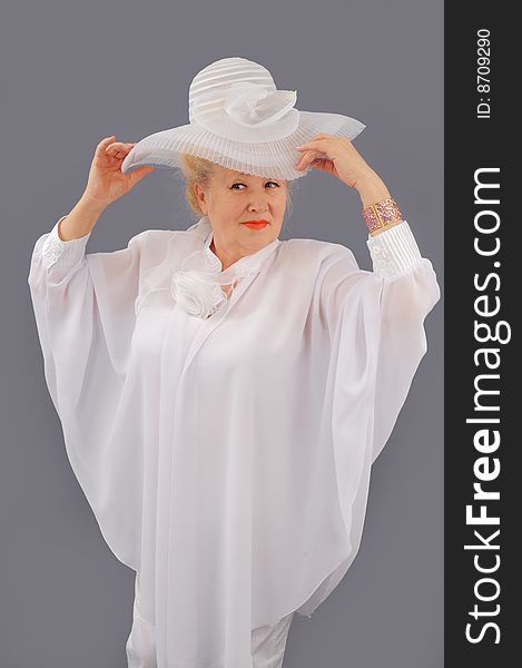 The woman the blonde in white clothes and a white hat. The woman the blonde in white clothes and a white hat.