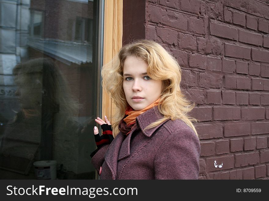 Girl standing near a window outdoor