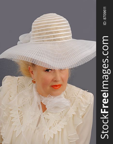 The woman the blonde in white clothes and a white hat. The woman the blonde in white clothes and a white hat.