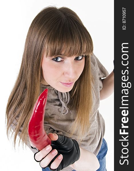 Young blue eyes girl with red paprika in hand.