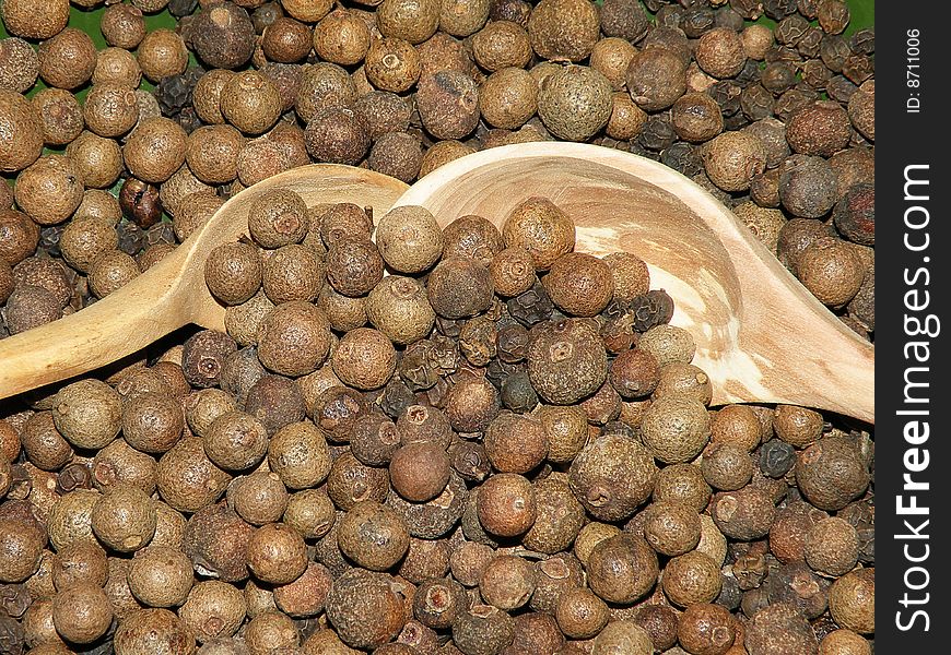 Two wooden spoon and pepper for background, spices