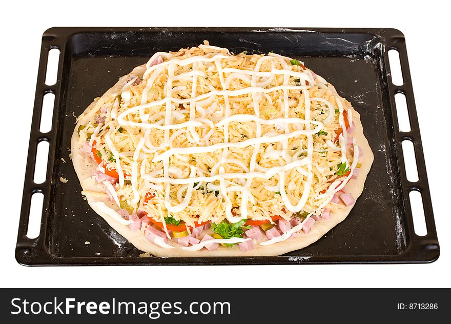 Raw pizza on baking tray, isolated on white