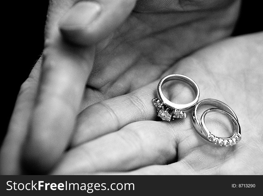 Wedding rings in groom's hands. Wedding rings in groom's hands