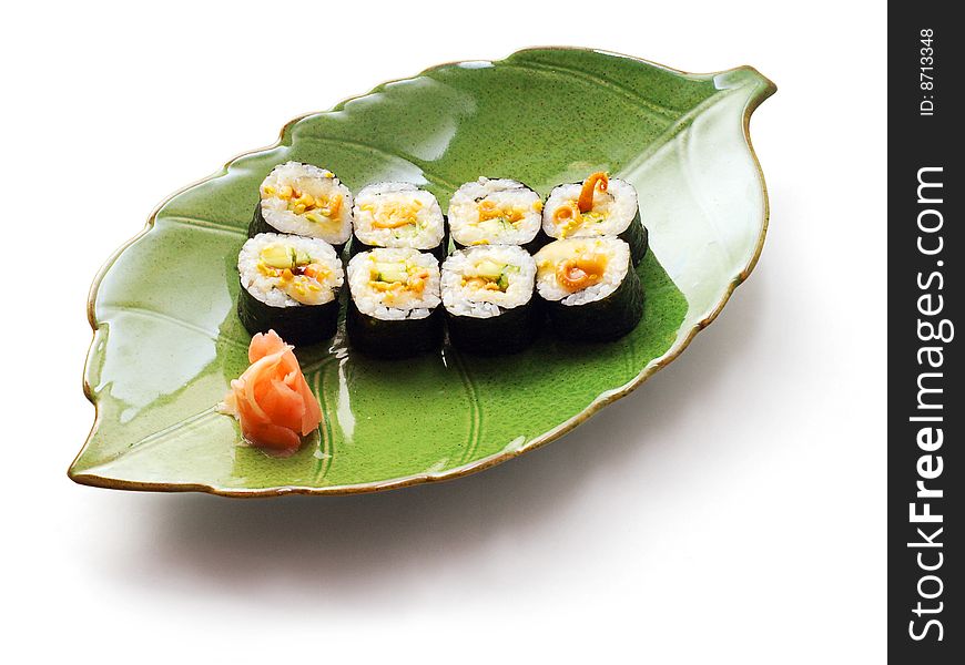 Rolls with octopus and cucumber in green leaf plate over white background