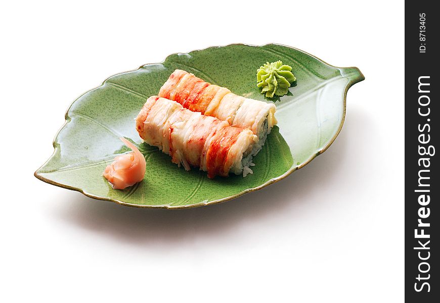 Rolls with crabmeat and tuna in green leaf plate over white background