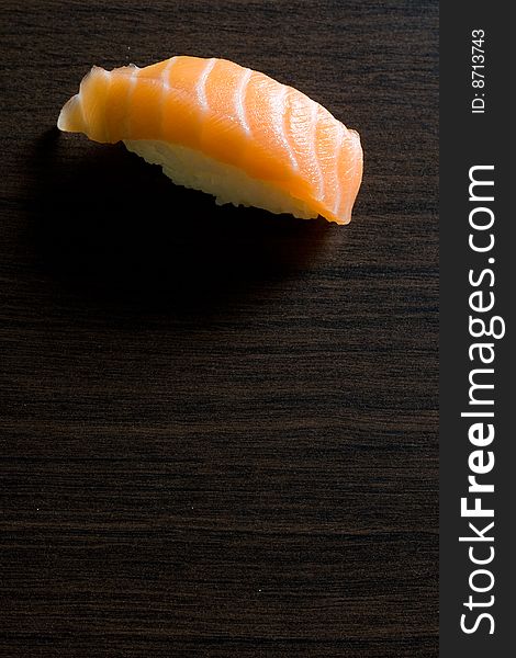 Fish sushi on wooden brown board