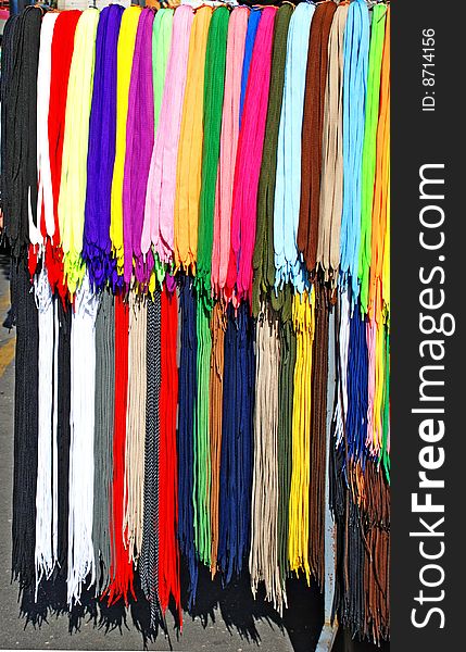 Multicolored new laces hanging in row on sale. Multicolored new laces hanging in row on sale