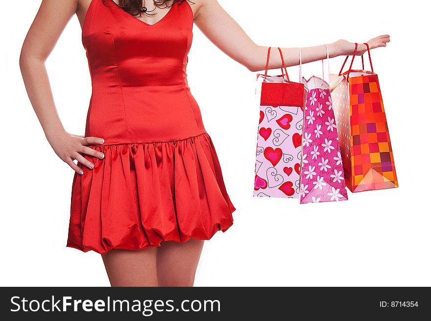 Young shopper - woman in red dress with shopping bags. Young shopper - woman in red dress with shopping bags