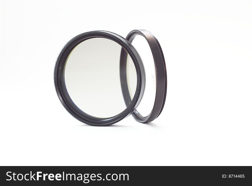 Two camera lens filters on white