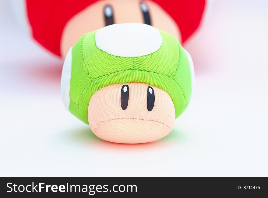 Green Plush Mushroom With Red At The Back On White