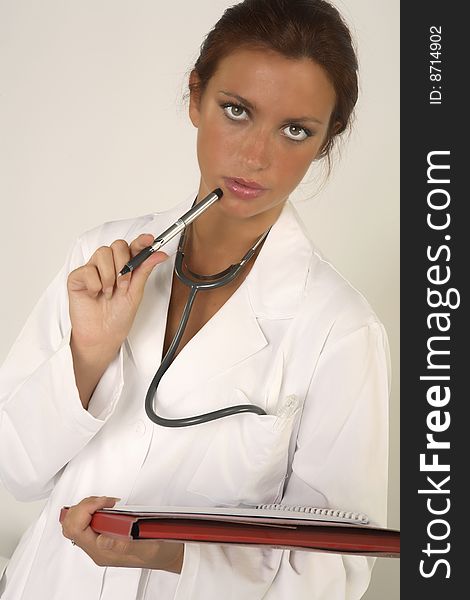 Female doctor with stethoscope on white