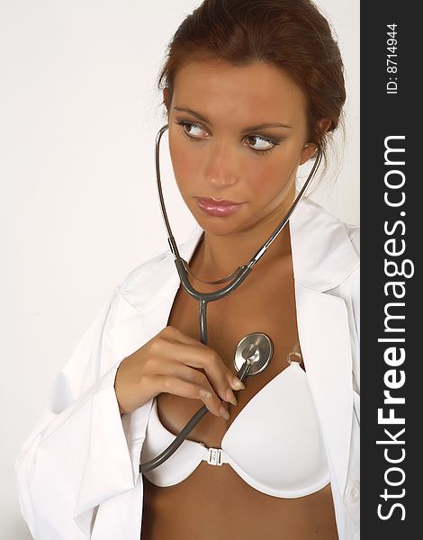 Female doctor with stethoscope on white